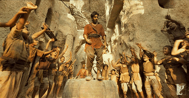 a man in a red shirt is surrounded by a group of people