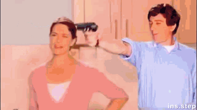 a person is holding a gun in front of a pink circle