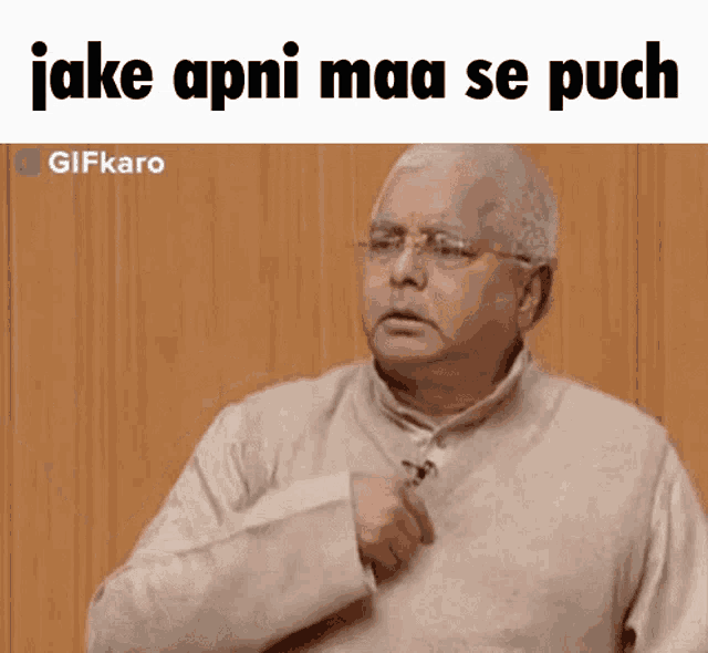 a man wearing glasses is making a funny face with the words jake apni maa se puch written above him .
