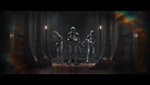 a group of clone troopers are standing in a dark hallway .