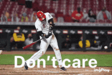 a baseball player is swinging a bat with the words " do n't care " behind him