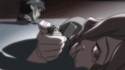 a person is holding a lighter in front of another person laying on the floor