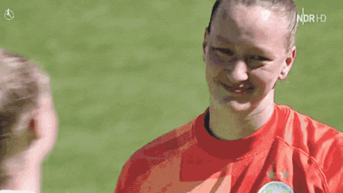 a woman in a red shirt with the word north on the bottom