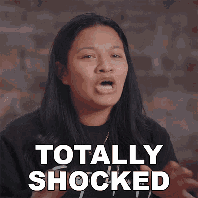 a woman is making a face and the words totally shocked are behind her