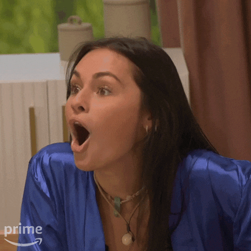 a woman wearing a blue robe with her mouth open is a prime member