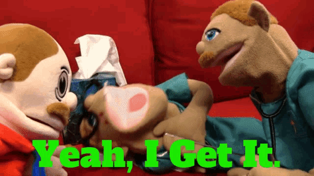 two stuffed animals on a red couch with the words yeah i get it on the bottom