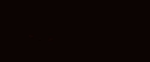 a man and a woman are sitting in a dark room .