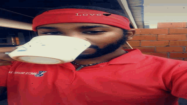 a man wearing a red shirt that says ' hollywood ' on it