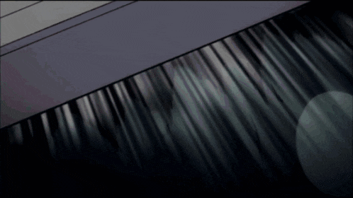 a dark room with a few lights shining through the curtain
