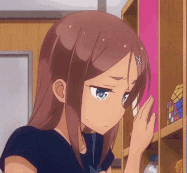a girl with a x on her head is looking at a shelf