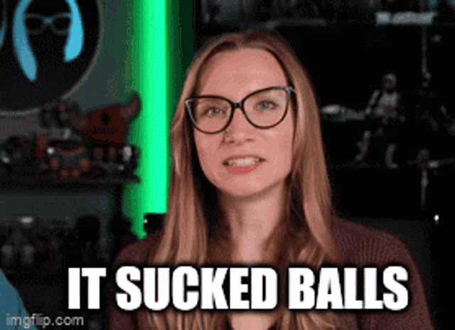 a woman wearing glasses says it sucked balls in front of a green background