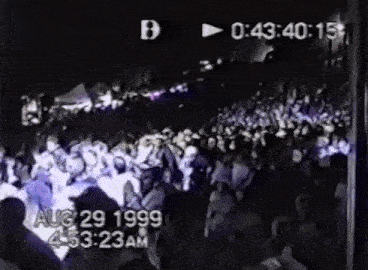 a black and white photo of a crowd of people taken on aug 29 1999