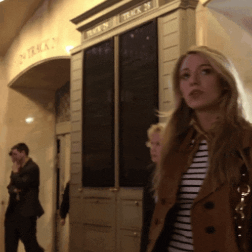 a woman stands in front of a sign that says virgin on it