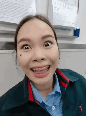 a woman with braces on her teeth making a face