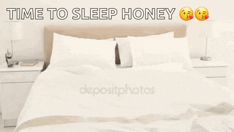 a woman in a towel is jumping on a bed with the words `` time to sleep honey '' written above her .