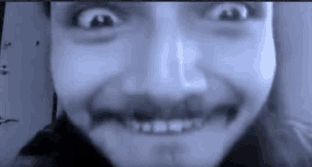 a close up of a person 's face with a slight smile on it