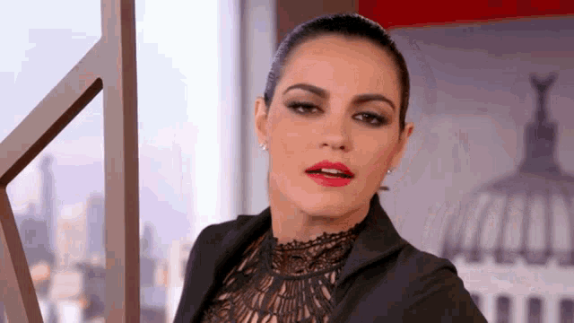 a woman with red lipstick and a black jacket