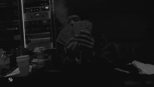 a black and white photo of a man holding a bunch of money with a watermark that says ink
