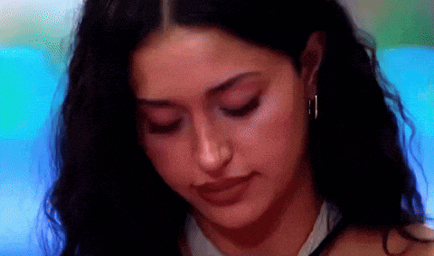 a close up of a woman 's face with earrings on