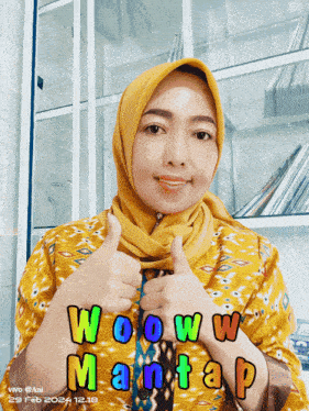 a woman wearing a hijab giving a thumbs up with the words wow mantap below her