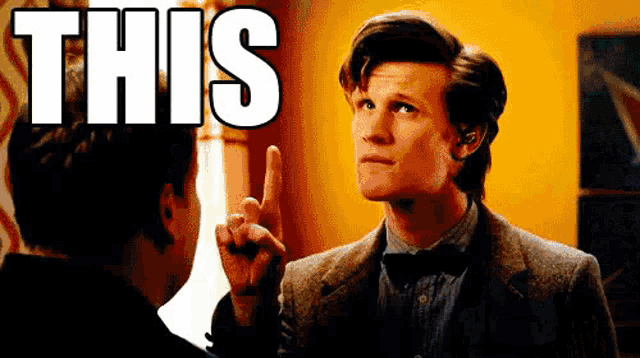 a man in a suit and bow tie is pointing up with the word this in the background