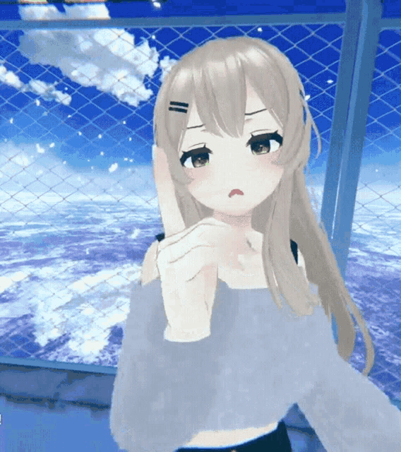 a girl with long hair is standing in front of a chain link fence