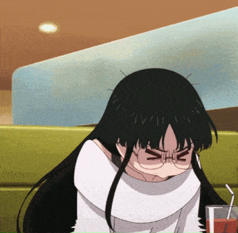 a girl with long black hair and glasses is sitting in a chair
