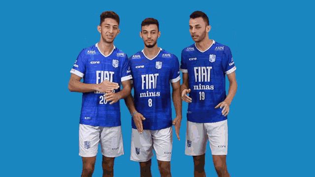 three soccer players wearing blue jerseys with fiat minas on them