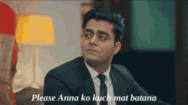 a man in a suit and tie says please anna ko kuch mat batana