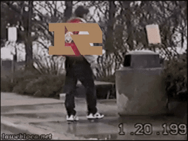 a person walking down a sidewalk with the letter r on their back