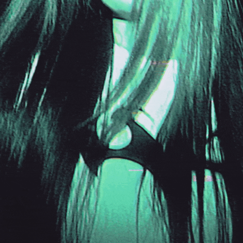 a woman with long black hair is wearing a black bikini