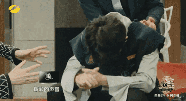 a man in a green jacket is being held by a man in a blue suit and tie