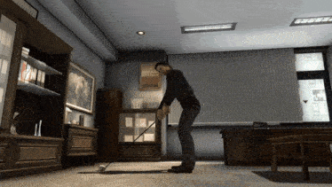 a man is playing golf in a room with a picture of a horse on the wall