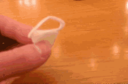 a person holding a ring in front of a pot with the name charlie on it