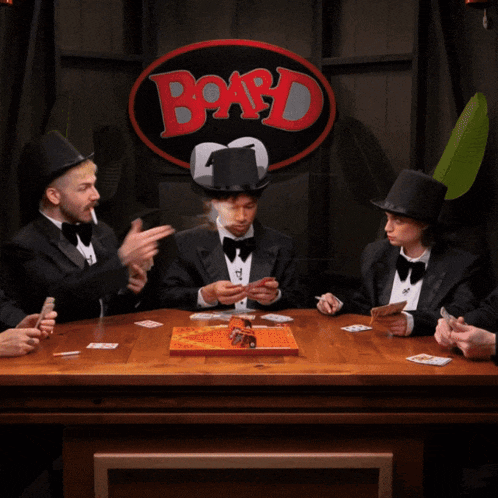 a group of men are playing a board game with fire coming out of their heads