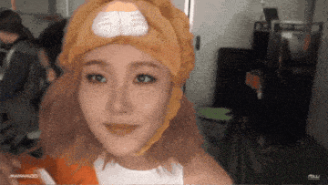 a woman wearing a cat hat with the word mamamoo on the bottom left