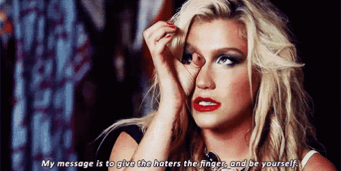 a woman is crying and saying `` my message is to give the haters the finger and be yourself '' .