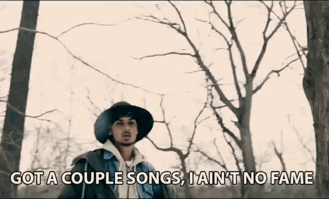 a man standing in the woods with the words got a couple songs i ain 't no fame written below him