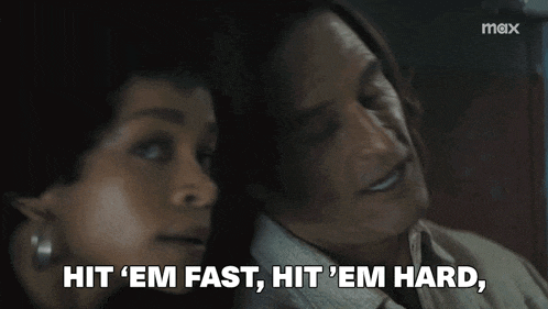 a man and a woman are sitting next to each other and the woman is saying hit em fast hit em hard
