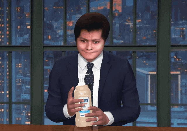 a man holding a bottle of purell hand sanitizer