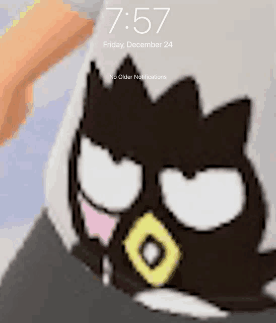 a phone screen shows a picture of a cartoon character and the time is 7:57