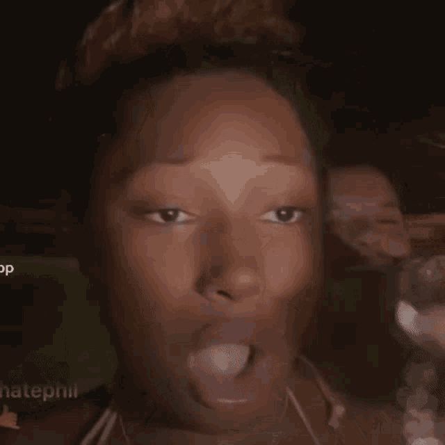 a close up of a woman making a funny face with her mouth open