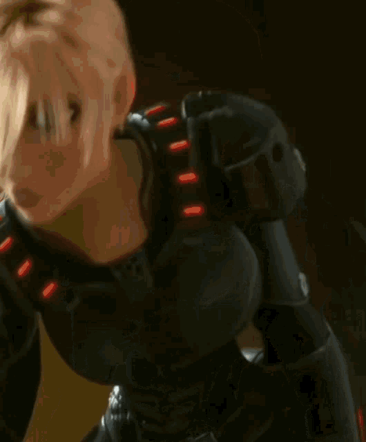 a cartoon character with short blonde hair wearing a black suit