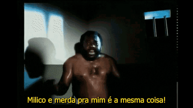 a man without a shirt is standing in a dark room with the words milico e merda pra mim