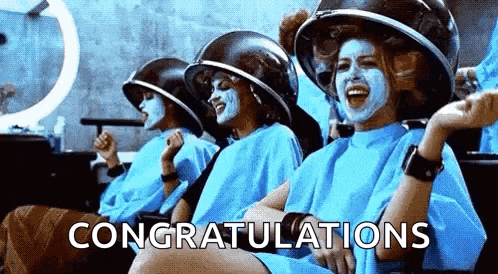 a group of women are sitting in a hair salon with face masks on .