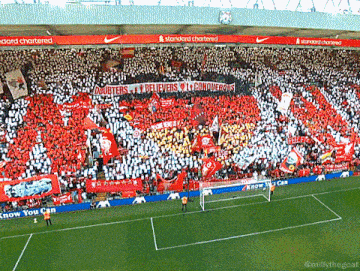 a soccer stadium with a banner that says " believers "