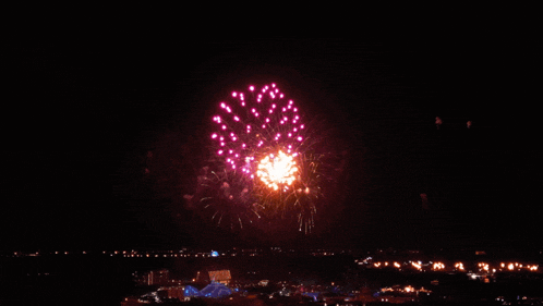 a fireworks display over a city with a lightning bolt
