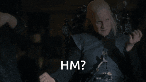 a man is sitting in a chair with the words hm written on the bottom