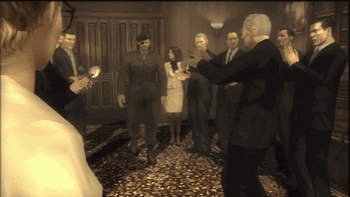 a group of people standing in a room with a woman in the middle