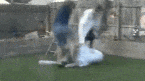 a man is kicking a soccer ball in a backyard